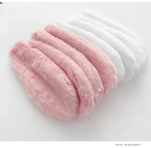 Detailed view showing the soft texture of pink and white plush rabbit ears decor