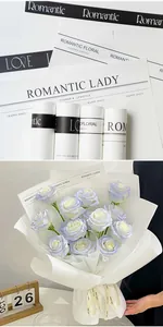 Detailed macro view of white floral wrapping paper featuring elegant black romantic print