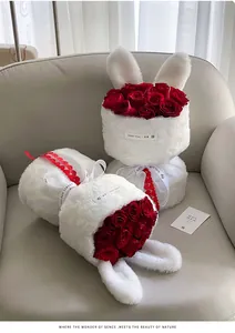 Close-up detail of plush bunny ear bouquet wrapping with romantic red roses on sofa