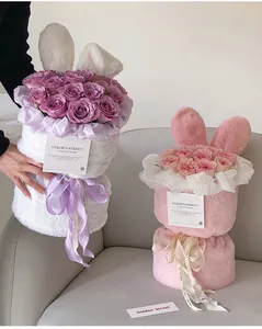 Close-up of DIY plush rabbit ear flower bouquet packaging in soft white and pink colors