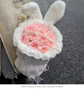 Detail view of romantic pink roses inside a plush white bunny ear floral gift wrap