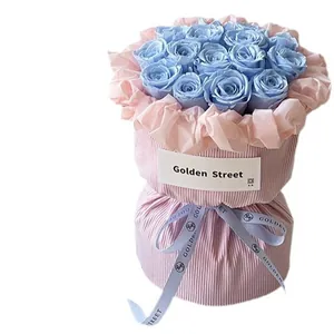 Light blue rose bouquet wrapped in pink pleated velvet fabric for Valentine's Day