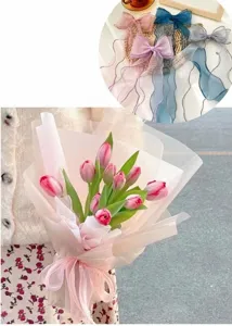 Detail view of pink fishtail yarn ribbon wrapping a bouquet of fresh tulips