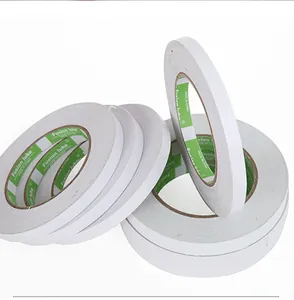 Macro detail of multi-pack white double-sided tape rolls for floral and office use