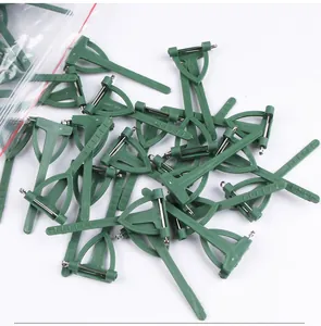 Detail view of bulk green plastic boutonniere pins for wedding floral arrangements.