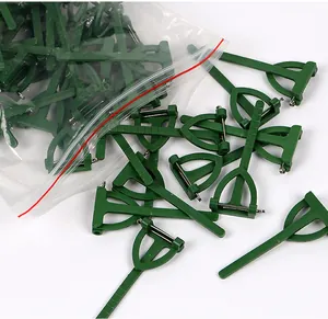 Detailed view of green triangular plastic corsage clips for wedding floral arrangements.