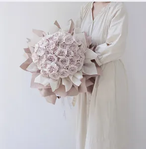 Detail of elegant macaron pink rose bouquet wrapped in waterproof Korean style paper