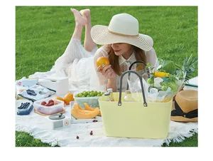 Detail view of woven texture plastic picnic basket used for flower arrangement in nature.