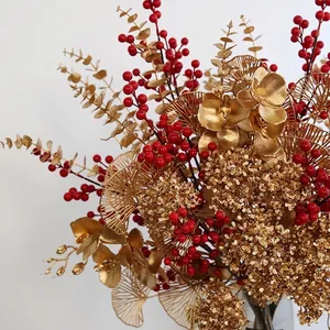 Festive artificial golden leaves and red berries floral arrangement for home decoration
