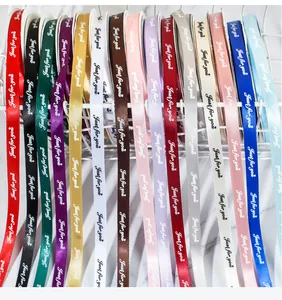 Macro view of multi-colored 1cm polyester ribbons featuring 'Just for You' text print