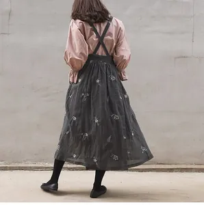 Back view of a French pastoral charcoal linen apron featuring delicate white floral embroidery