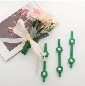 Detailed view of green magnetic boutonniere clips used for wedding floral corsages.