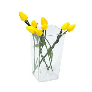 Minimalist transparent square acrylic flower bucket featuring several bright yellow tulips.