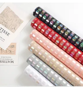 Detailed view of colorful polka dot mesh fabric rolls for gift and flower wrapping