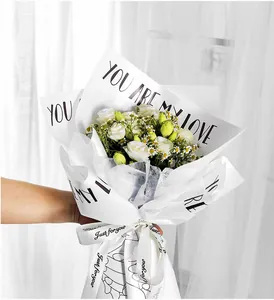 Close-up of waterproof pearlescent flower wrapping paper with romantic typography