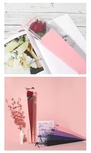 Detail of elegant triangular single rose boxes in assorted colors for floral gifting.