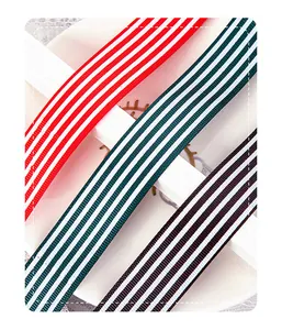 Detailed macro view of red, teal, and black striped grosgrain ribbons for DIY floral wrapping