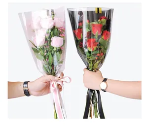 Detailed view of romantic flower wrapping bags with Love Rules text for roses