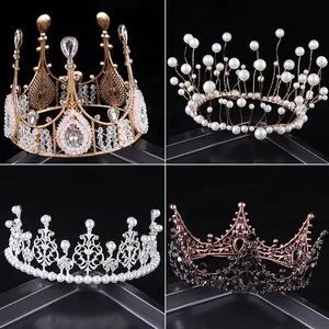 Macro view of four elegant bridal tiaras in gold, silver, black and pearl styles.