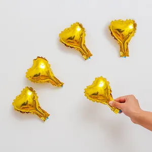 Close-up view of 5-inch gold heart foil balloons for wedding and party decorations