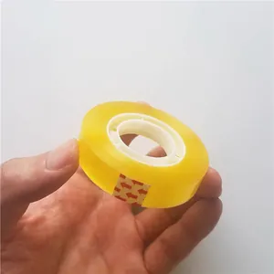 Close-up of a small roll of transparent yellow adhesive tape for floral DIY and office use