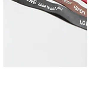 Close-up detail of polyester ribbon with engraved LOVE! none is not you text pattern