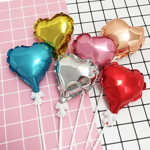 Detailed close-up of 5-inch heart-shaped foil balloons in assorted metallic colors