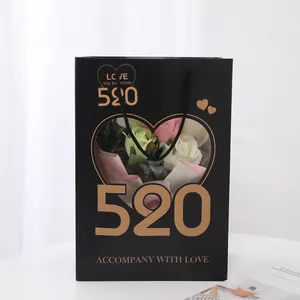Elegant black Valentine's Day gift paper bag with heart-shaped window and gold 520 printing