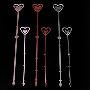 Close-up view of heart-shaped plastic flower picks in pink, red, and transparent colors