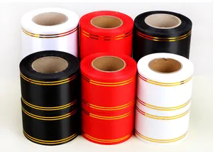 Close-up of assorted satin ribbons with gold borders for floral arrangements