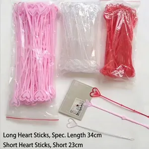 Heart-shaped plastic flower picks and card holders in pink, red, and clear colors.
