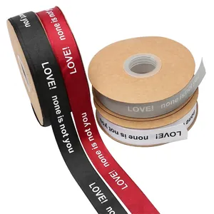 Four rolls of decorative grosgrain ribbons with printed text for floral gift packaging