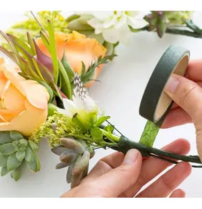Close-up of green floral tape wrapping flower stems for DIY handmade bouquet crafts