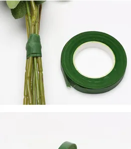 Close-up detail showing green floral tape neatly wrapped around artificial flower stems