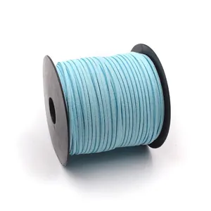 Light blue double-sided faux suede cord on a black spool for DIY floral crafts