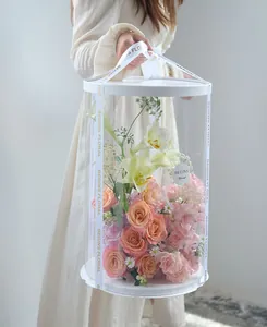 Premium large transparent round flower bucket packaging box with white lid and elegant floral ribbon