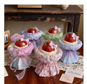 Macro view showing multiple finished DIY strawberry cake bouquets in colorful wraps