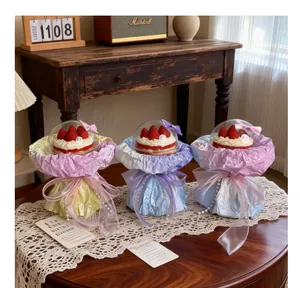 Detail view of DIY strawberry cake bouquet packaging with colorful paper and ribbons.
