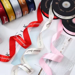Close-up of 2.5cm satin ribbons with 'Forever love' print for gift packaging