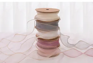 Elegant stack of pastel fish tail gauze ribbons with gold edges for flower wrapping decoration
