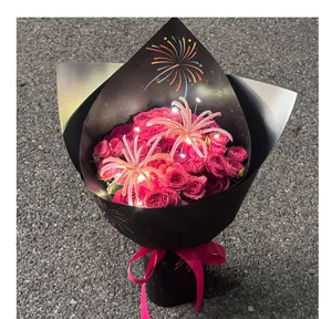 Detail view of fireworks-patterned black kraft paper bouquet wrap with LED lights.