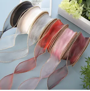 Close-up of assorted multi-colored fish tail sheer ribbons with gold braided edges