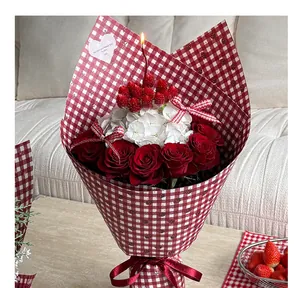Detail view of a bouquet wrapped in red and white checkered waterproof floral paper