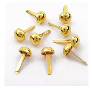 Detailed macro view of multiple gold metallic round head split pins for craft projects