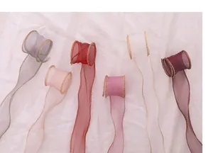 Macro detail of sheer organza ribbons with gold-wired edges in various colors