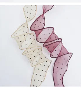 Detailed view of elegant polka dot chiffon fish tail ribbons for floral gift packaging.