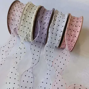 Close-up of polka dot chiffon ribbons with ruffled fishtail edges for gift wrapping