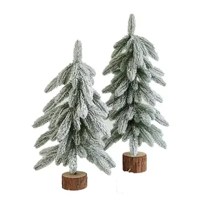 Mini artificial frosted Christmas trees with natural wooden bases for DIY holiday decor