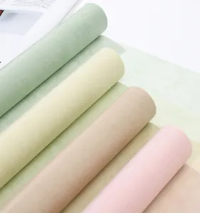 Close-up view of multi-colored milk cotton flower wrapping paper rolls with soft texture.
