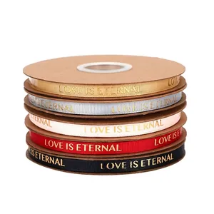 Stack of 1cm grosgrain ribbons with gold foil LOVE IS ETERNAL for elegant gift packaging